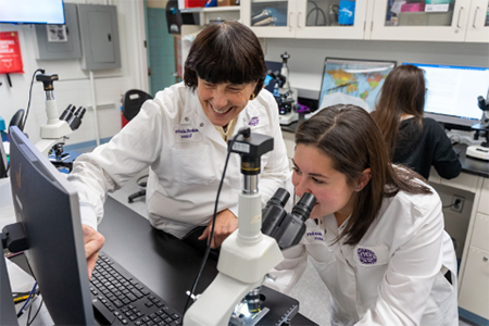 2 female grad students in lab coats